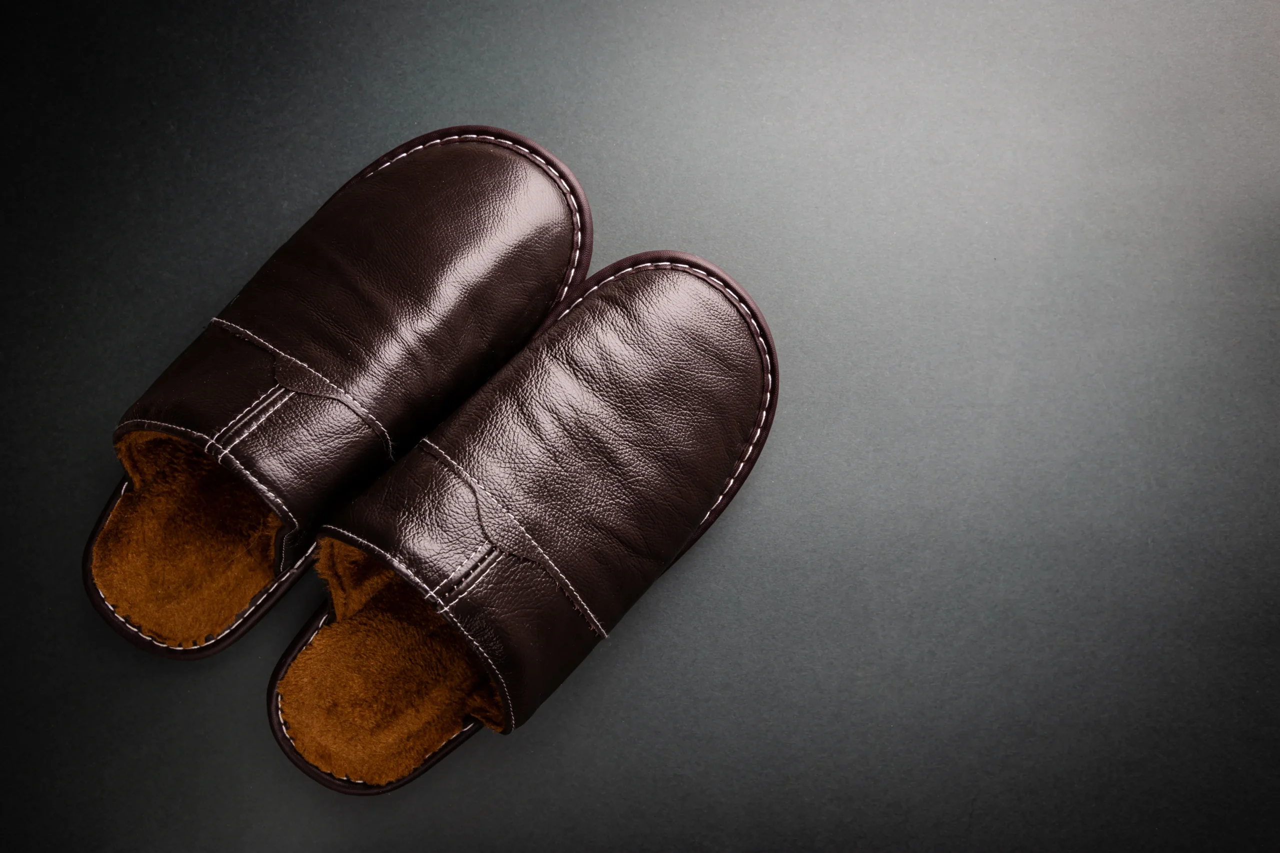 brown-leather-slippers-on-a-dark-background-2026-03-17-00-42-26-utc-converted-from-jpg
