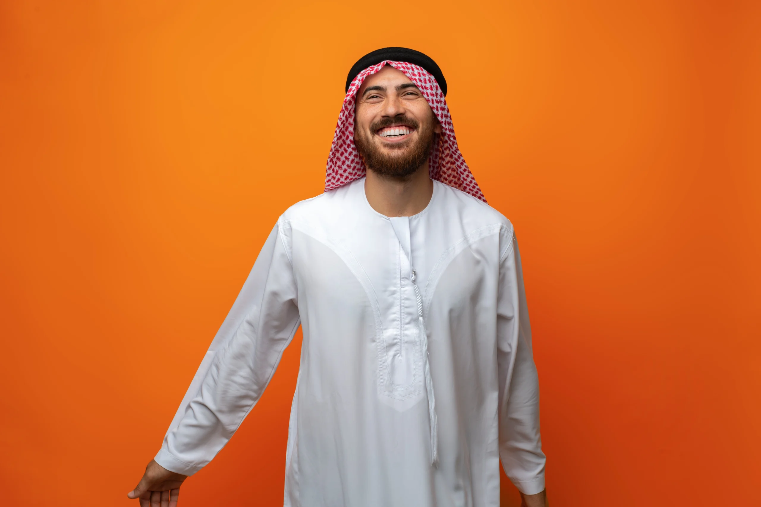 smiling-man-in-traditional-clothing-on-orange-back-2026-01-08-05-20-51-utc